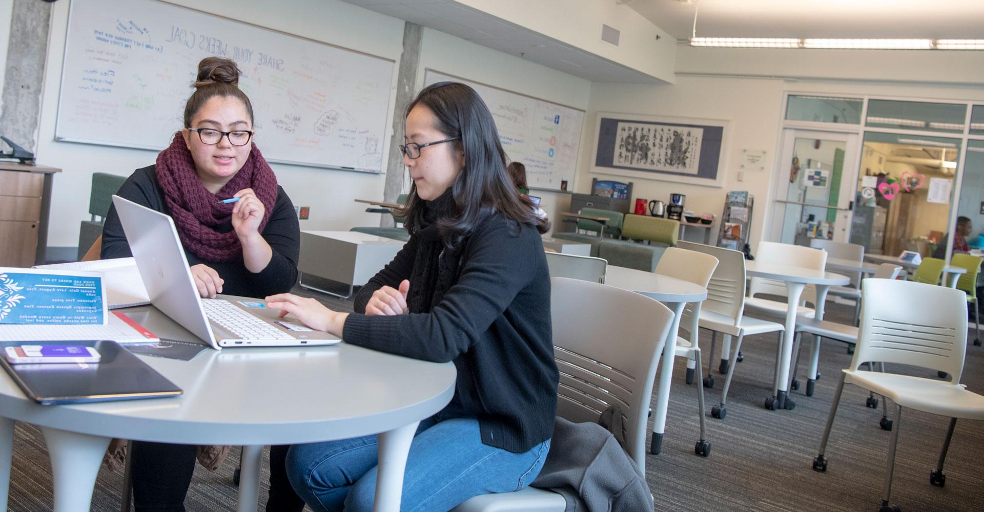 two women reviewing an assignment